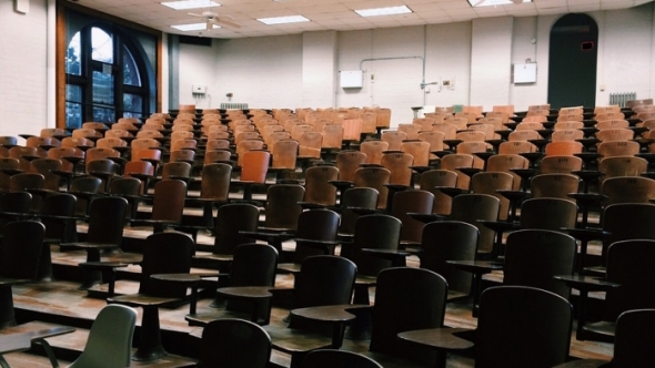 A photograph of an empty lecture hall style classroom.