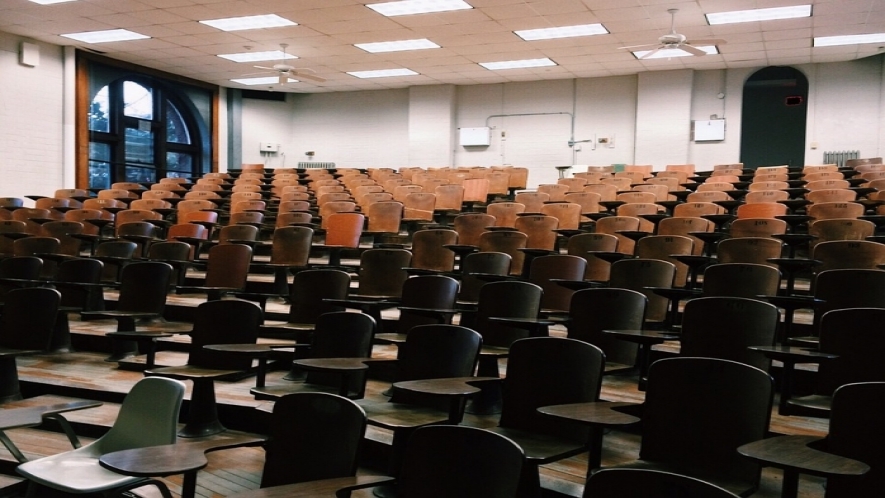 A photograph of an empty lecture hall style classroom.