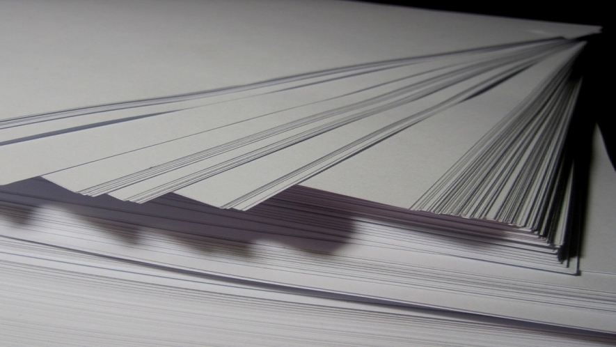 A photograph of a stack of printer paper. 