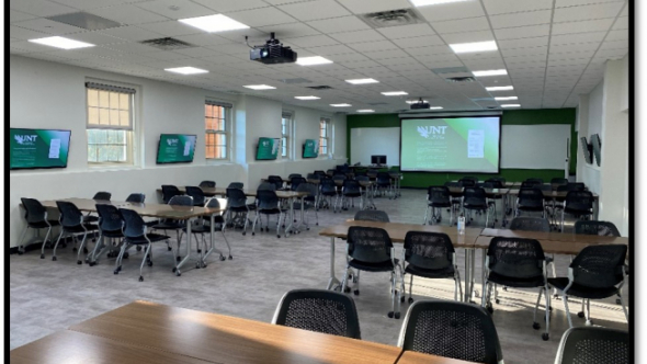 UNT CLAW 3 Active Learning Classroom in Sage Hall 230. Tables and chairs are on wheels and grouped.